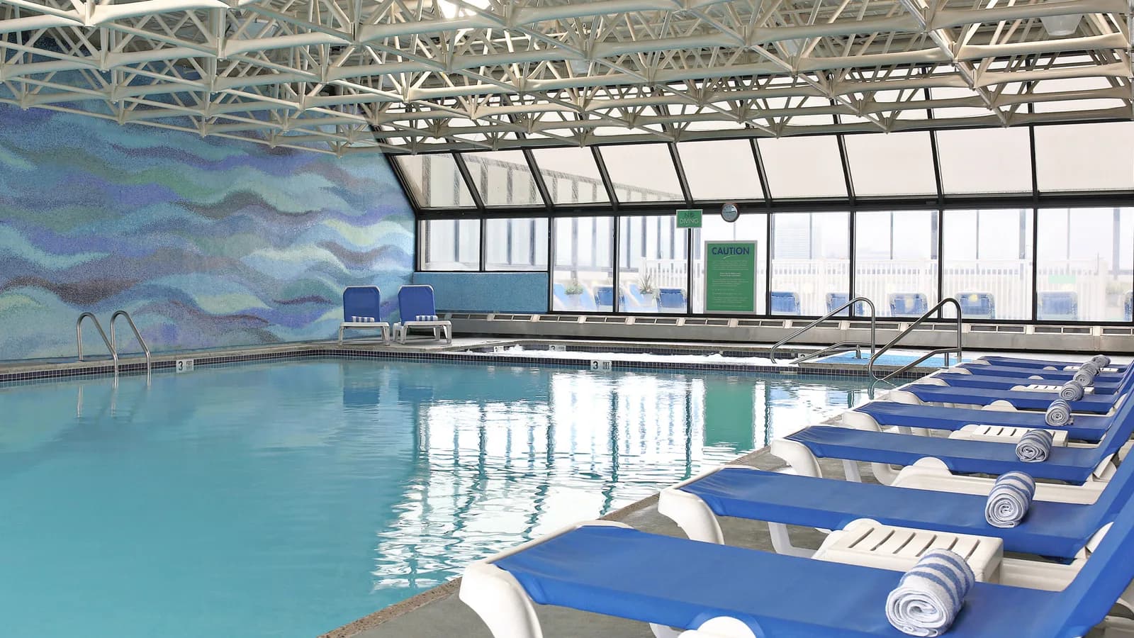 Indoor pool under a glass atrium at the Flagship Resort